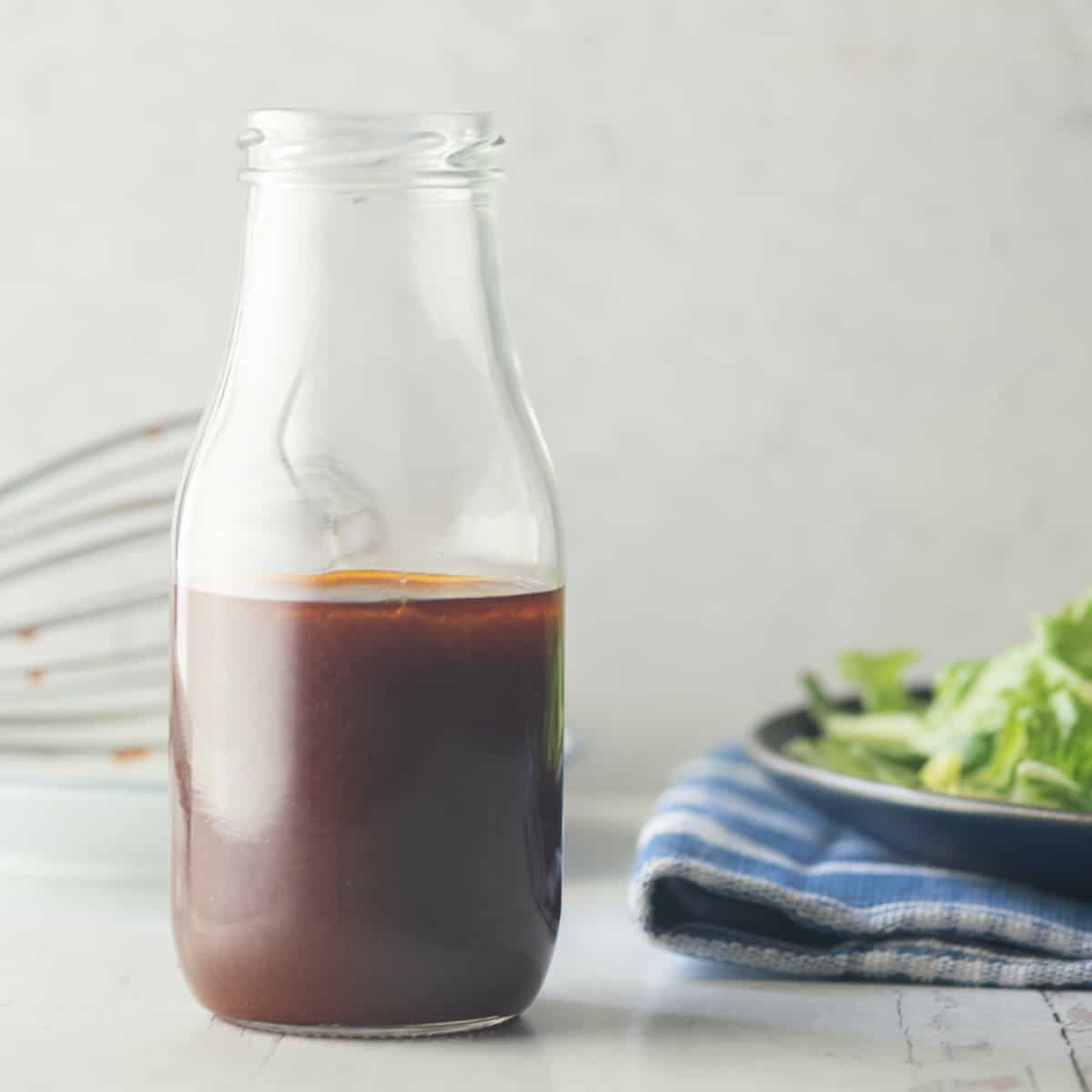 Barbecue Salad Dressing in small milk bottle, salad in background