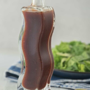 Barbecue Salad Dressing in curved bottle with salad in background