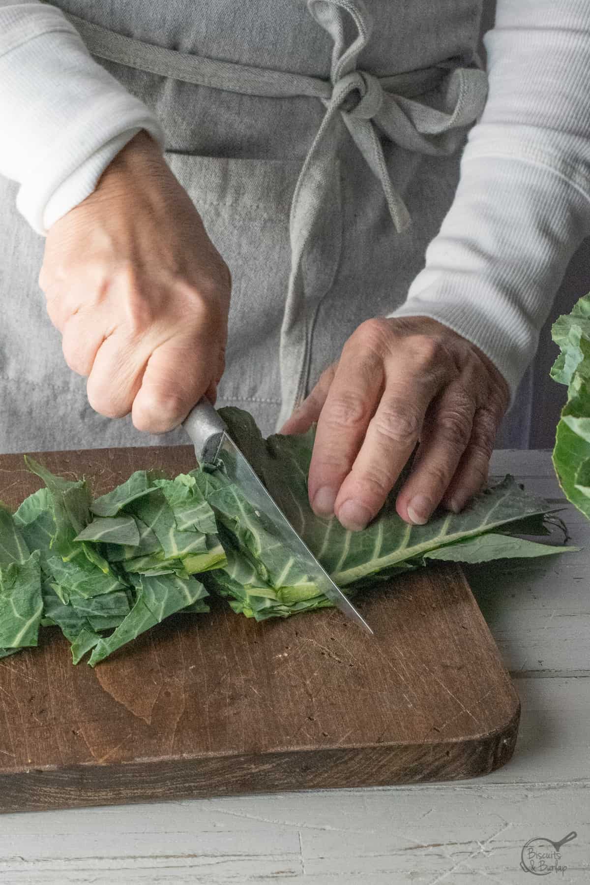 woman cutting collard greens.