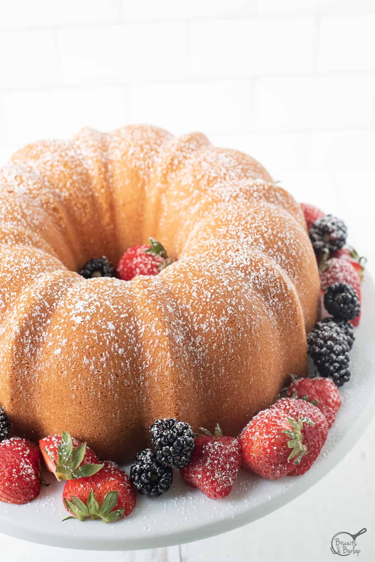 old fashioned cream cheese pound cake surrounded by berries