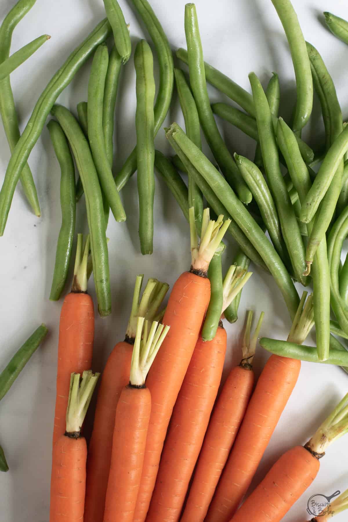 raw, fresh green beans and carrots.