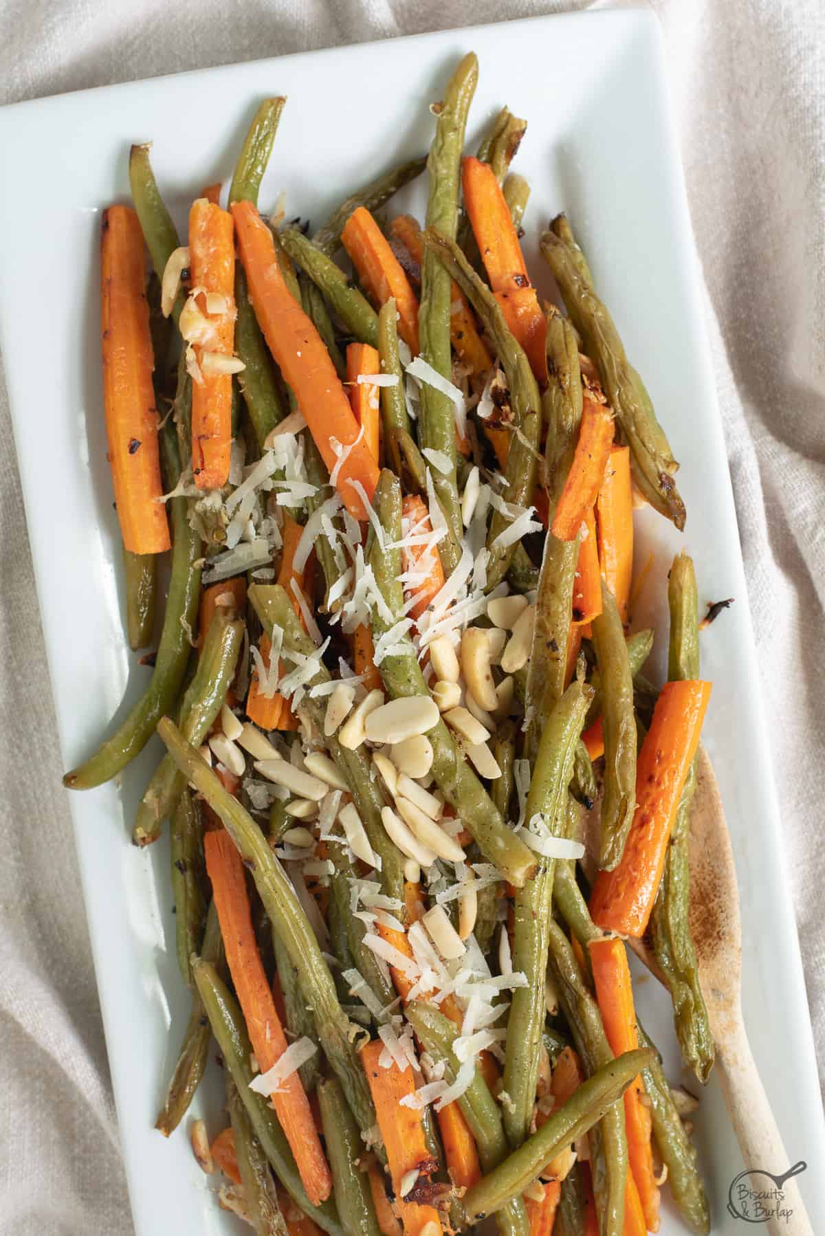 roasted carrots and green beans topped with cheese and almonds.