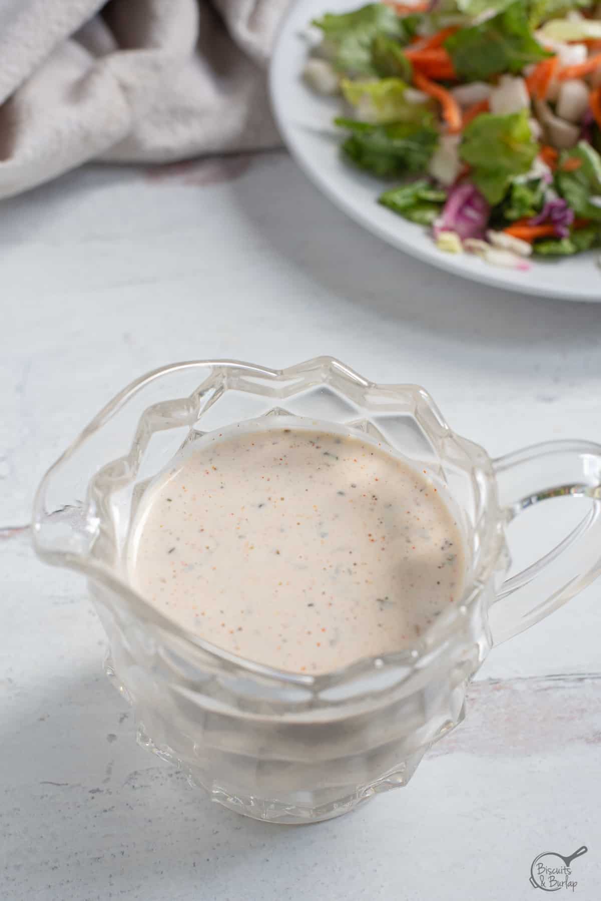 overhead image of a small pitcher with Cajun salad dressing