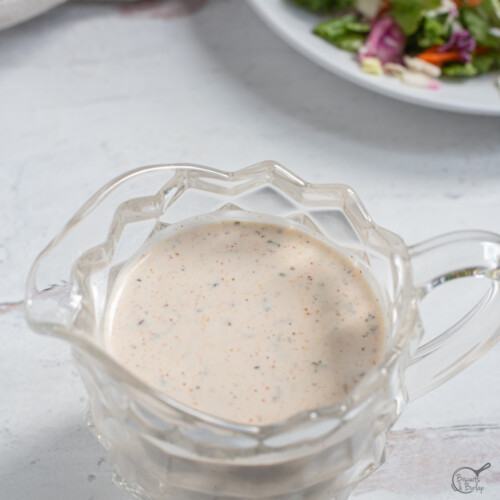 square image of Cajun Salad Dressing in glass pitcher.
