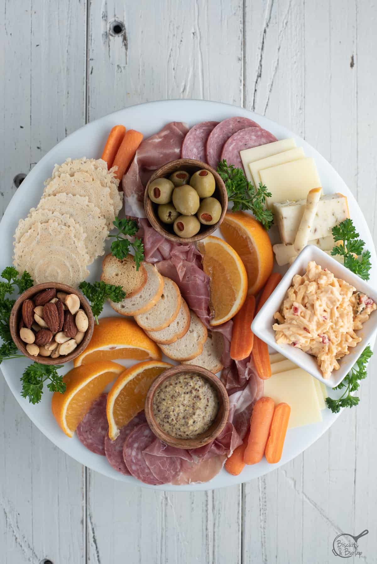 simple charcuterie board on white platter on white background