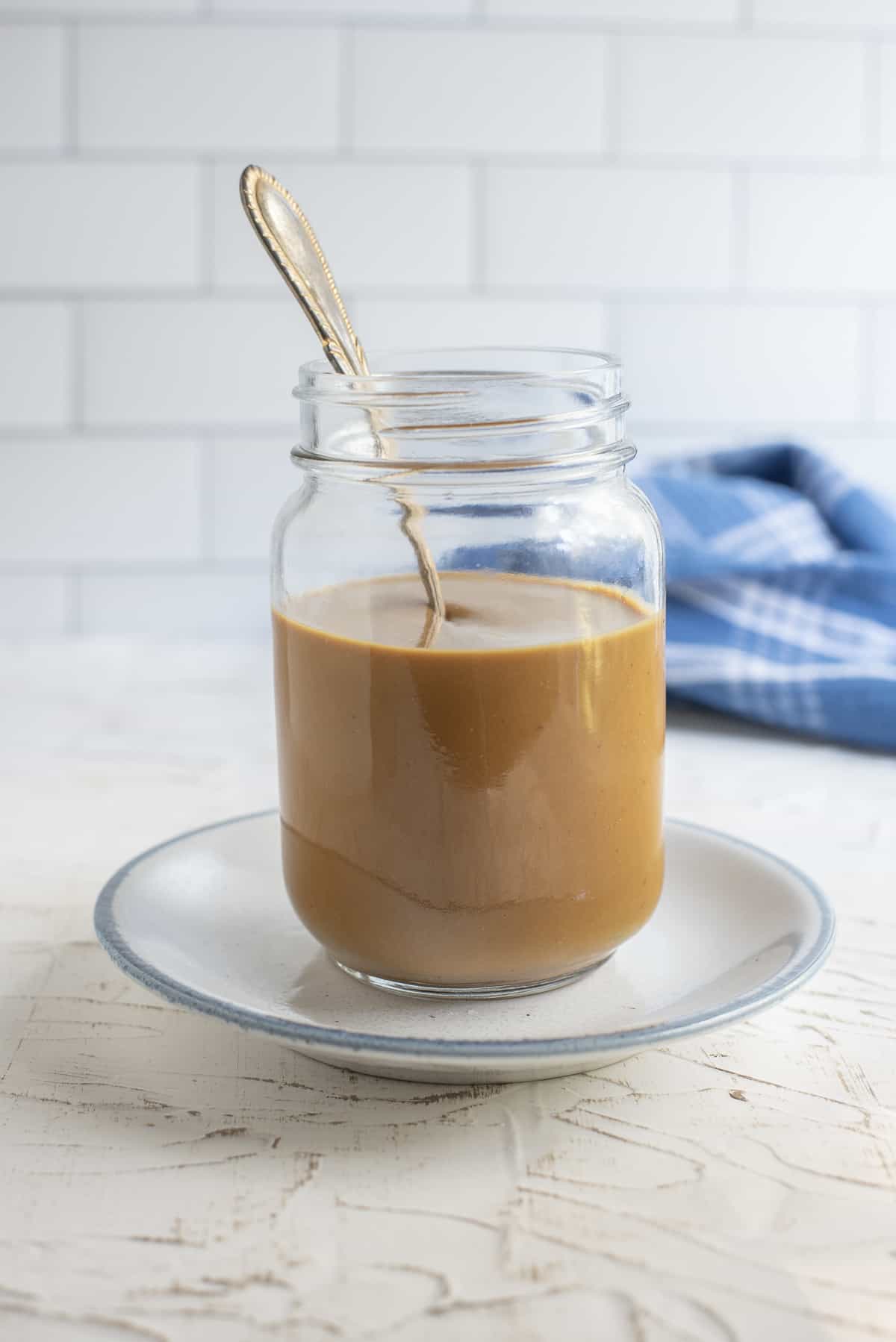 Georgia Mustard BBQ Sauce in a jar with a spoon