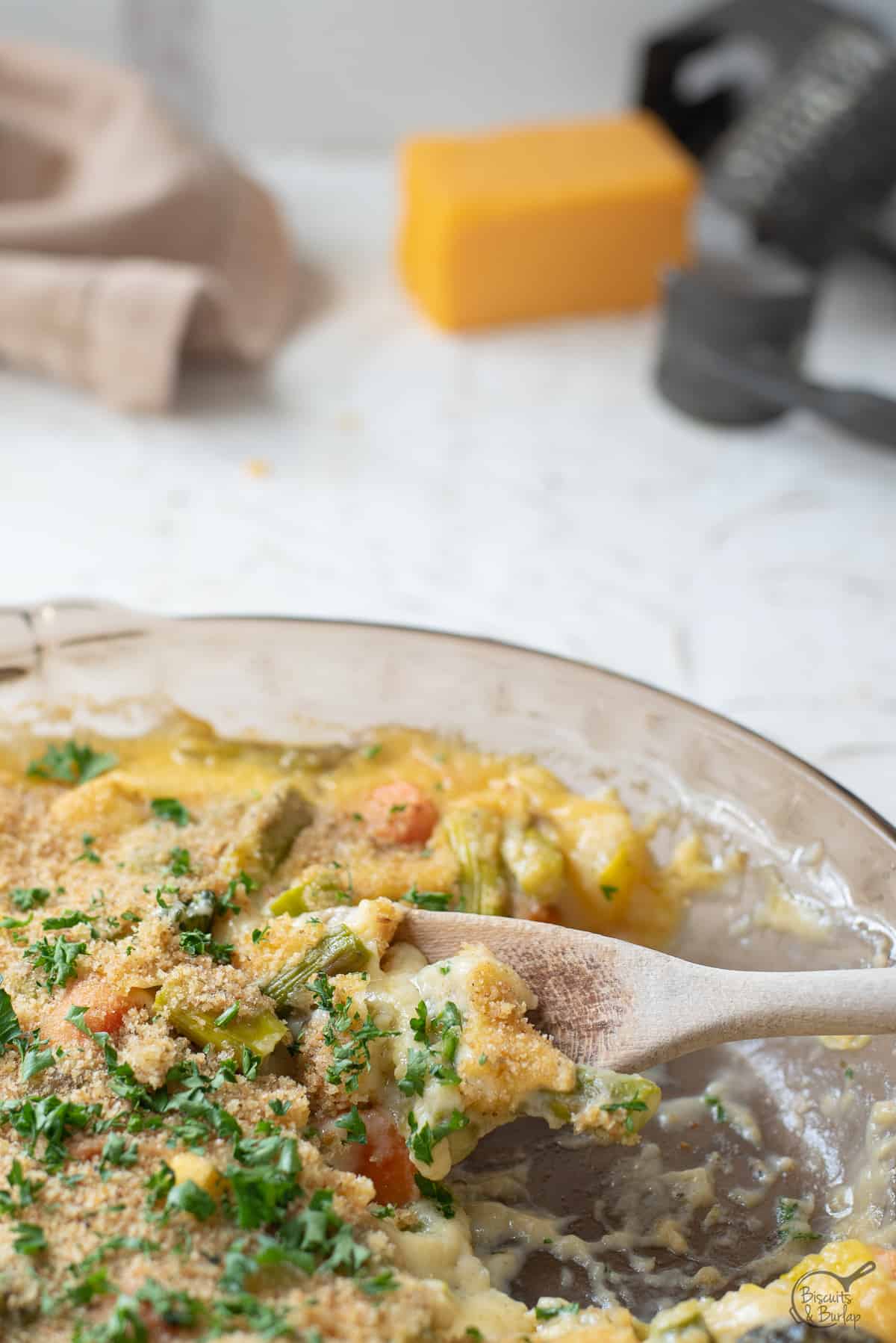 close up of spoonful of vegetables au gratin.