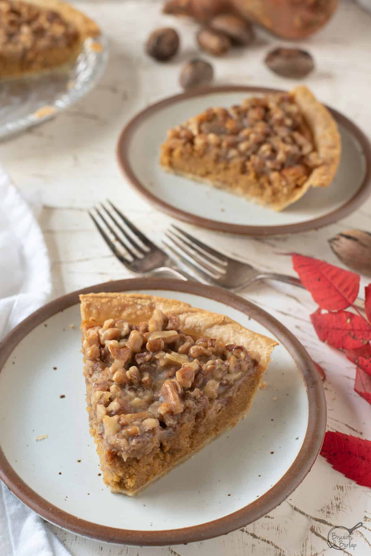 sweet potato praline pie slices on white plate with forks and white background