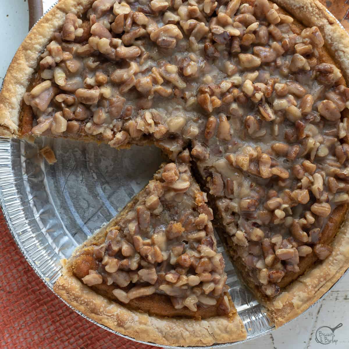 sweet potato praline pie with 1 slice missing