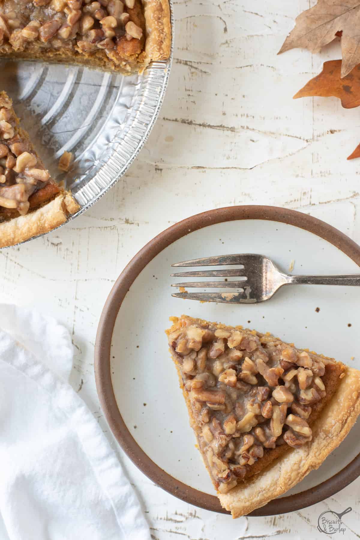 sweet potato praline pie slice on white plate with fork