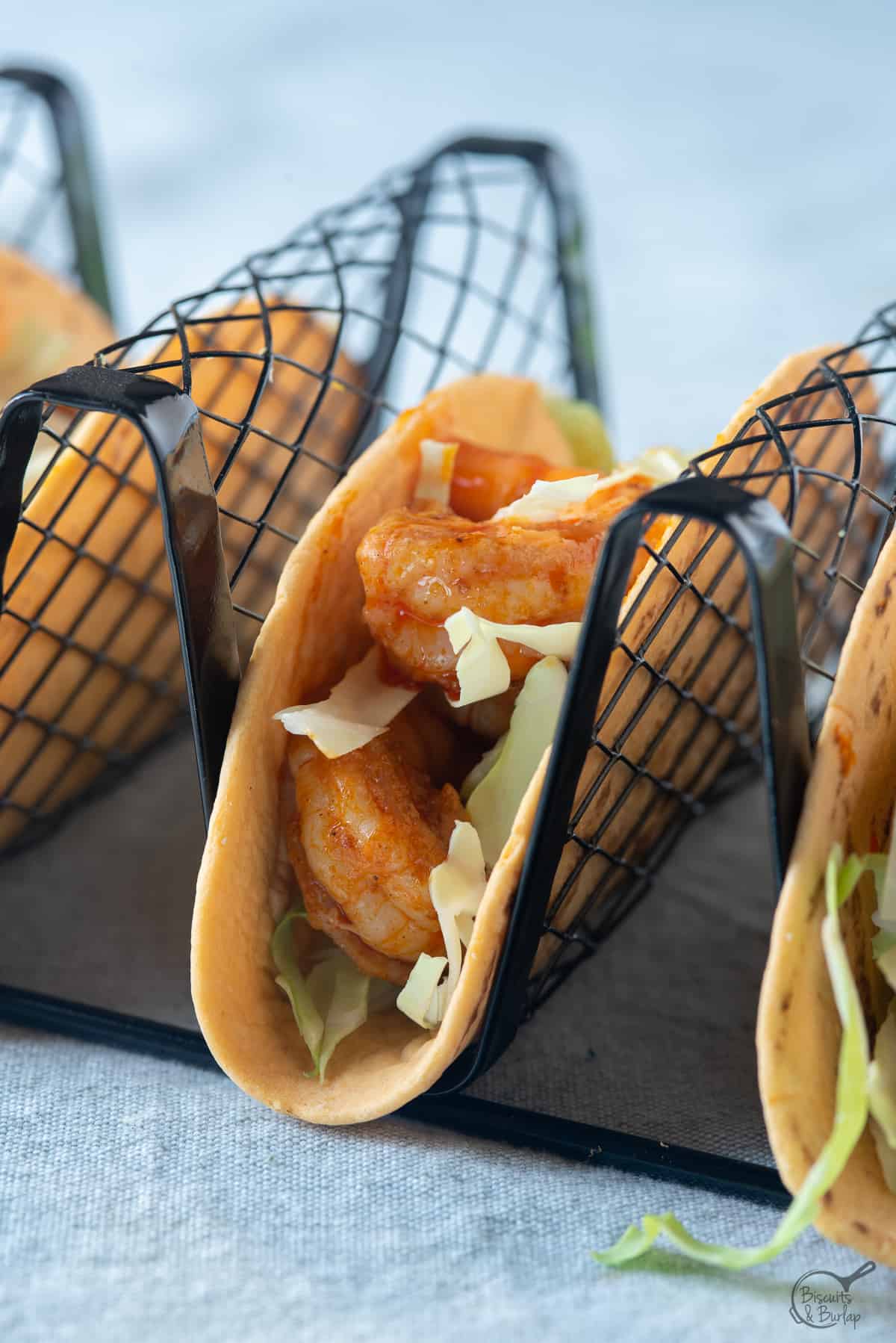 tacos made from buffalo style shrimp in stand. 