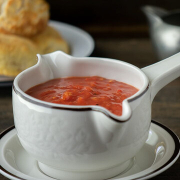 square image of homemade tomato gravy in gravy boat.