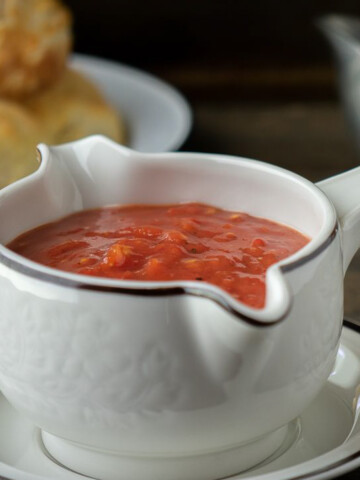 square image of homemade tomato gravy in gravy boat.