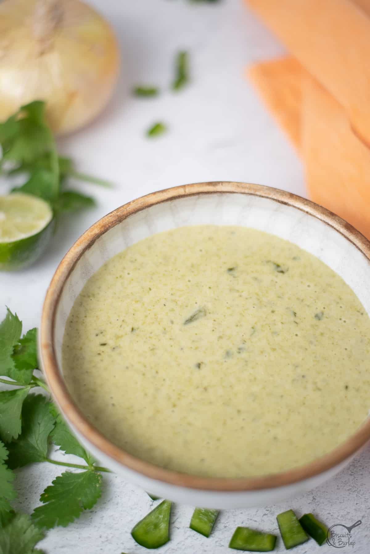 poblano sauce in bowl with ingredients around it.