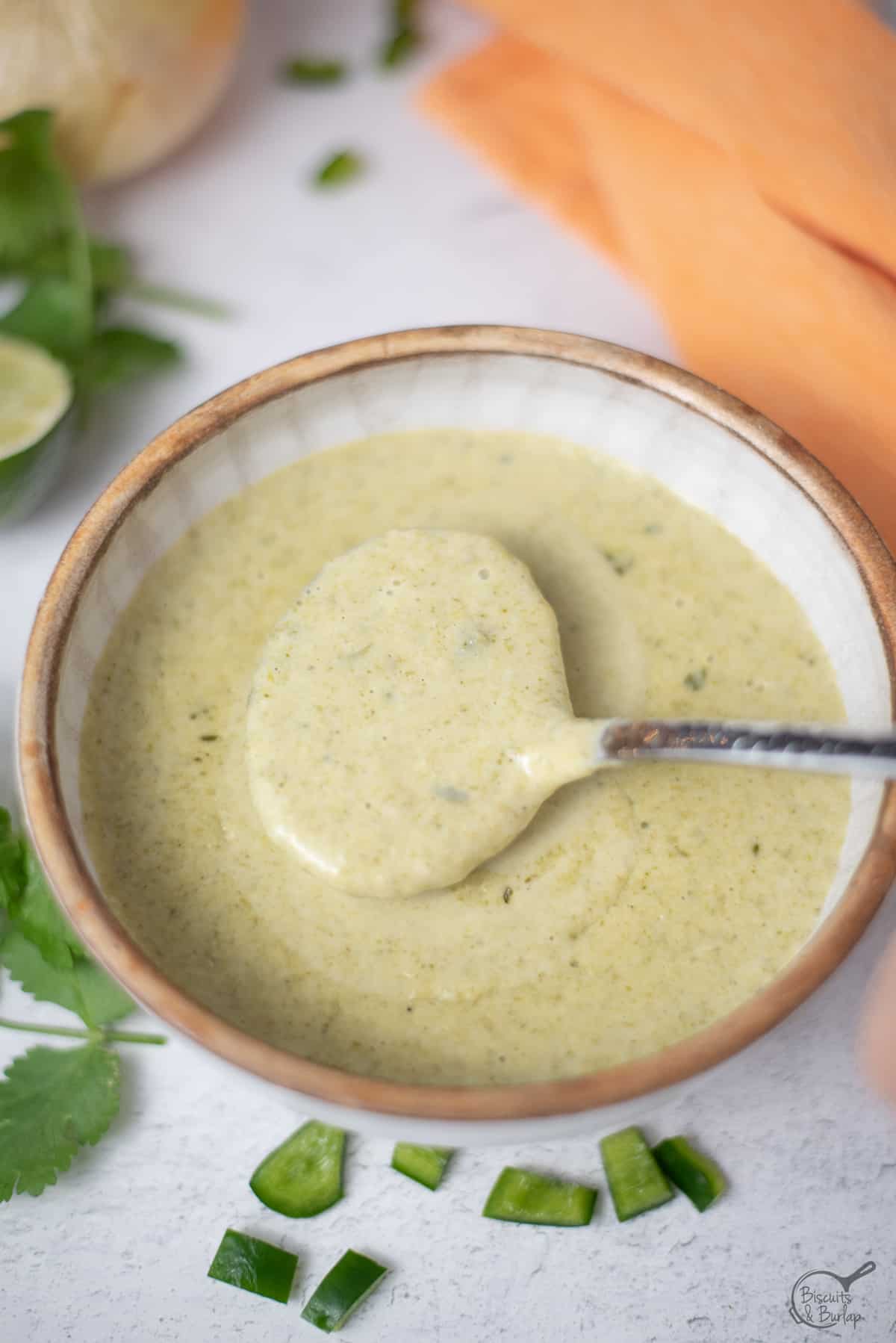 a spoonful of poblano cream sauce over bowl.