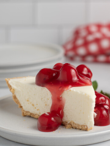 square image of 3 ingredient no bake cheesecake slice with cherry topping.