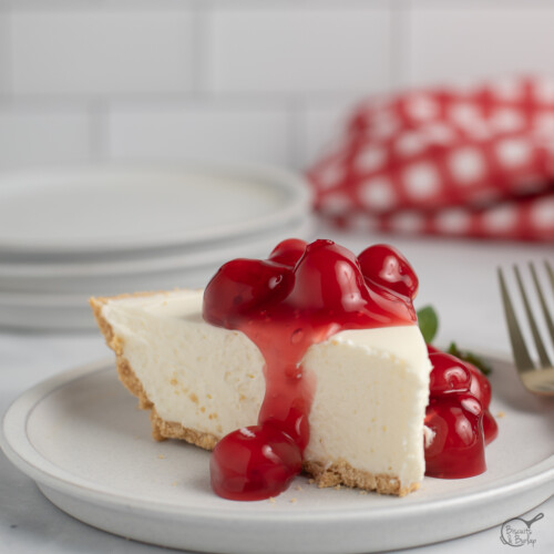 square image of 3 ingredient no bake cheesecake slice with cherry topping.
