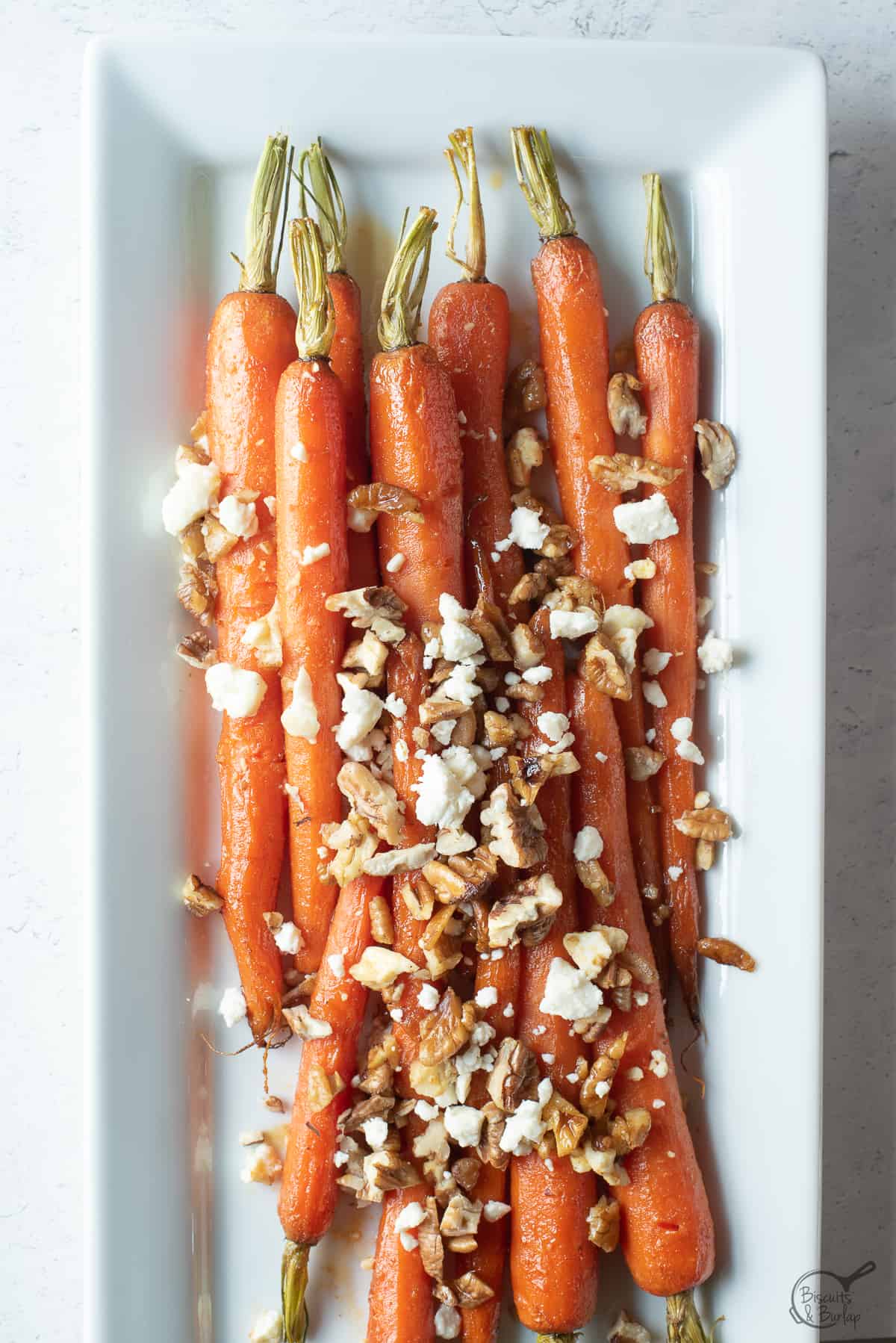 brown sugar glazed carrots on white dish. 