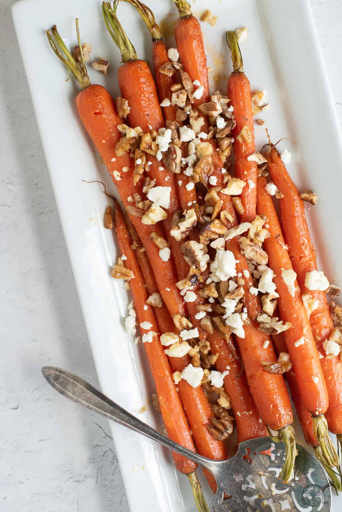white dish with brown sugar glazed carrots. 