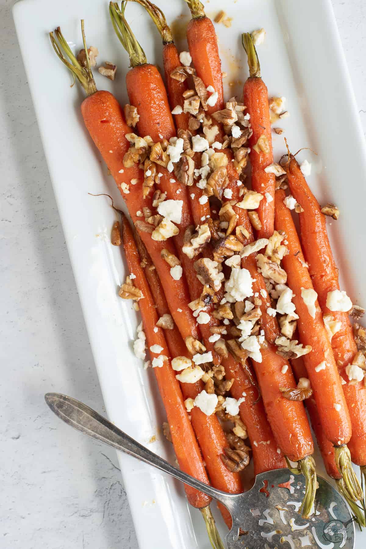white dish with brown sugar glazed carrots.