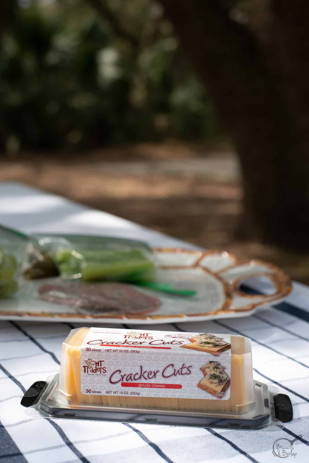 package of sliced cheese on picnic table. 