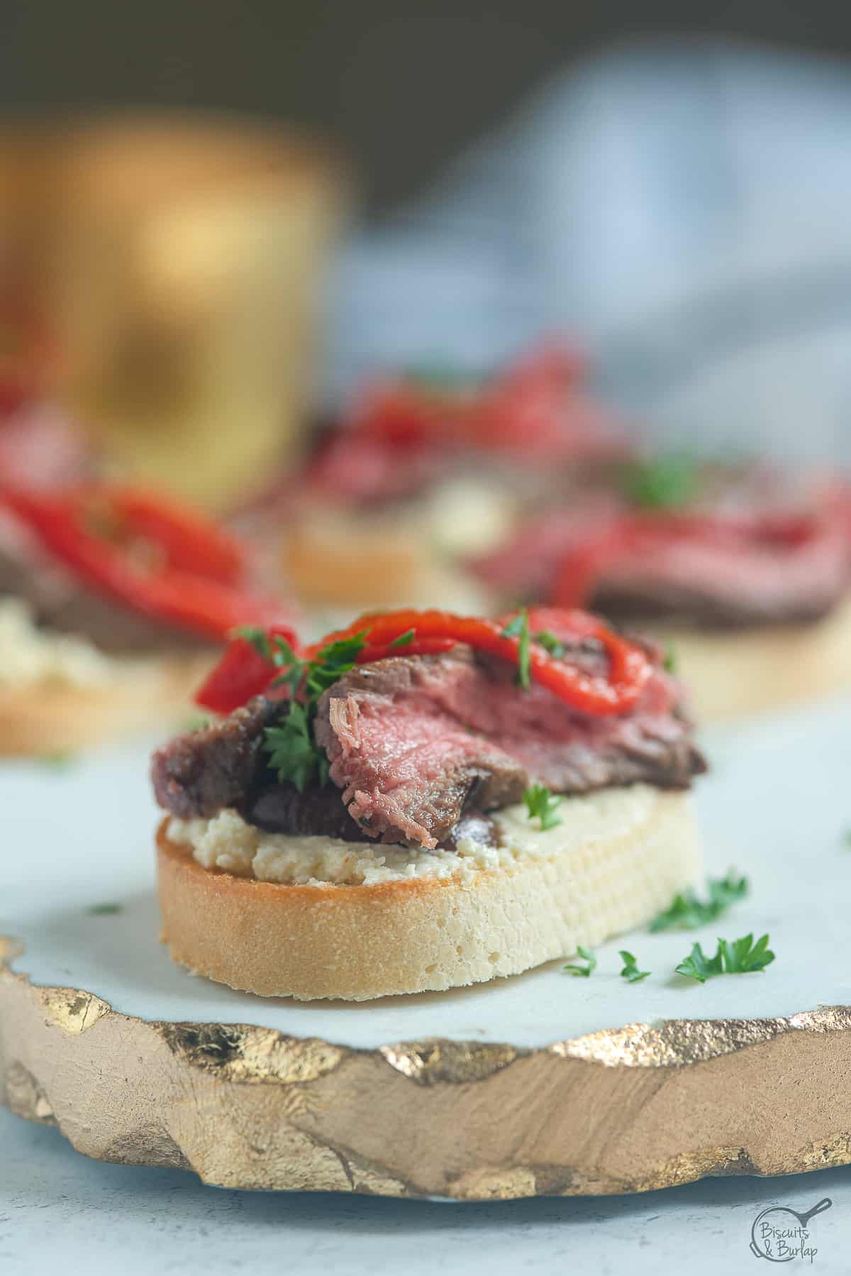 close up of steak crostini on tray.