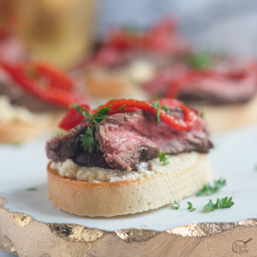 square image of steak crostini.