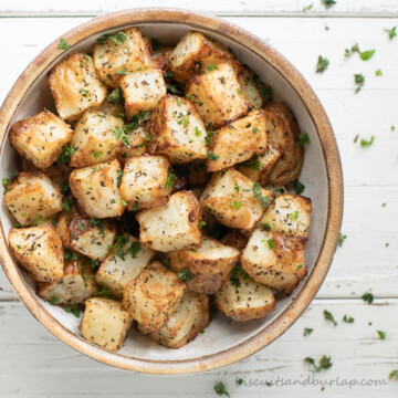 square image of air fryer potatoes in round bowl.