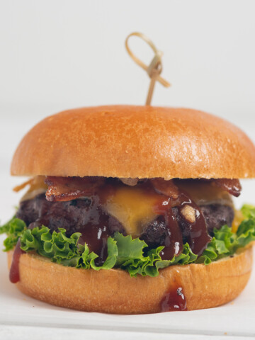 Bourbon Bacon Cheeseburger on white background