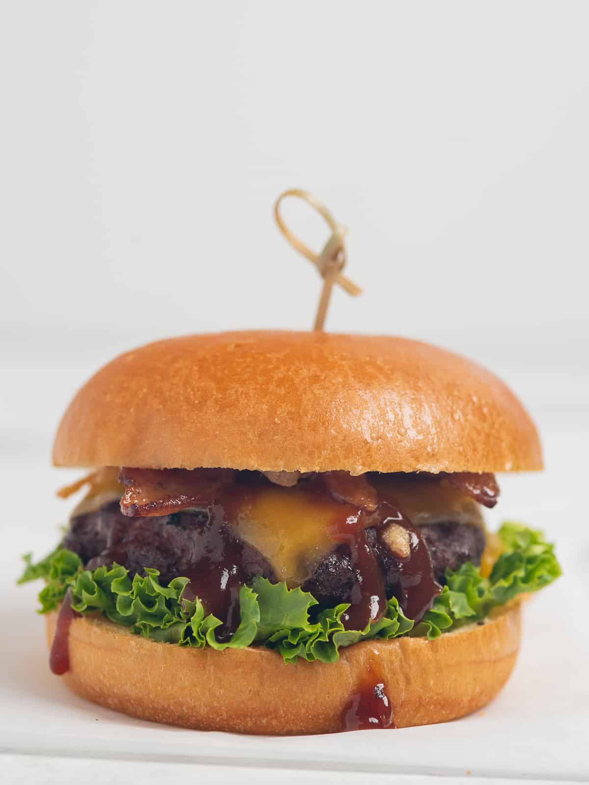 Bourbon Bacon Cheeseburger on white background