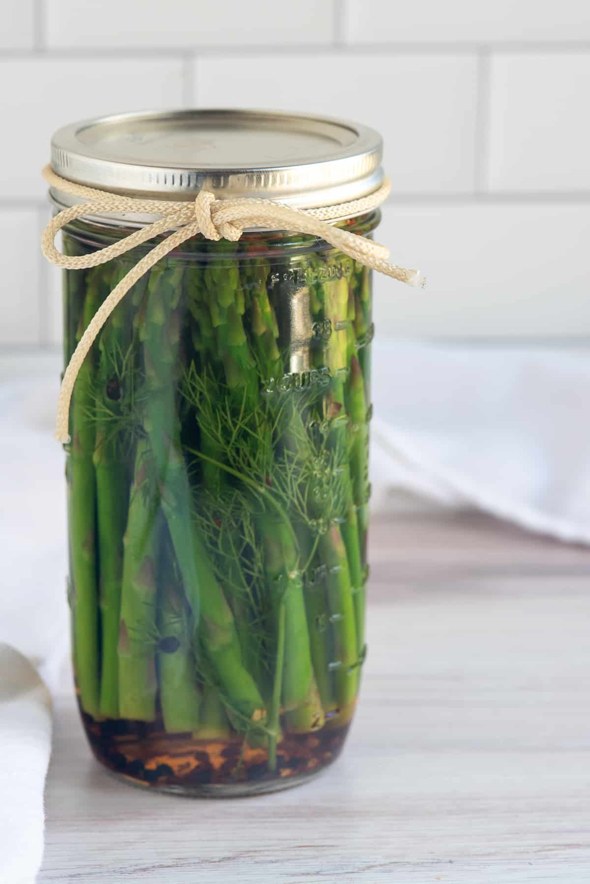 jar of pickled asparagus with bow. 