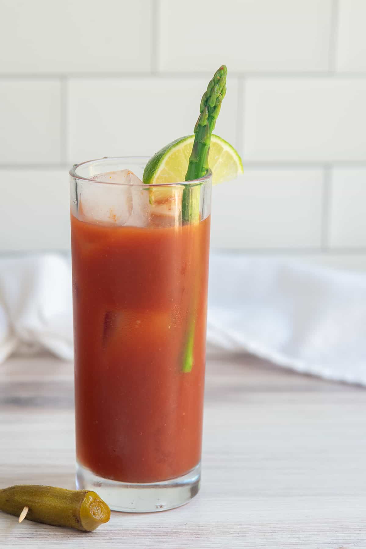 bloody mary with lime and pickled asparagus. 