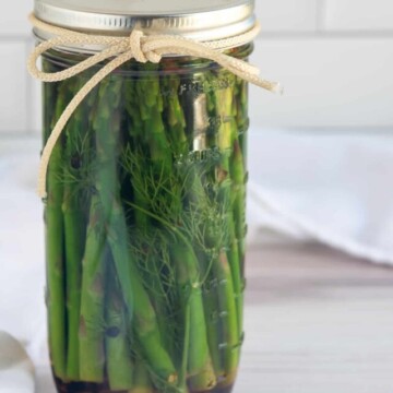 jar of pickled asparagus with bow.