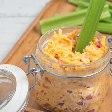 jar of pimento cheese with celery stick.