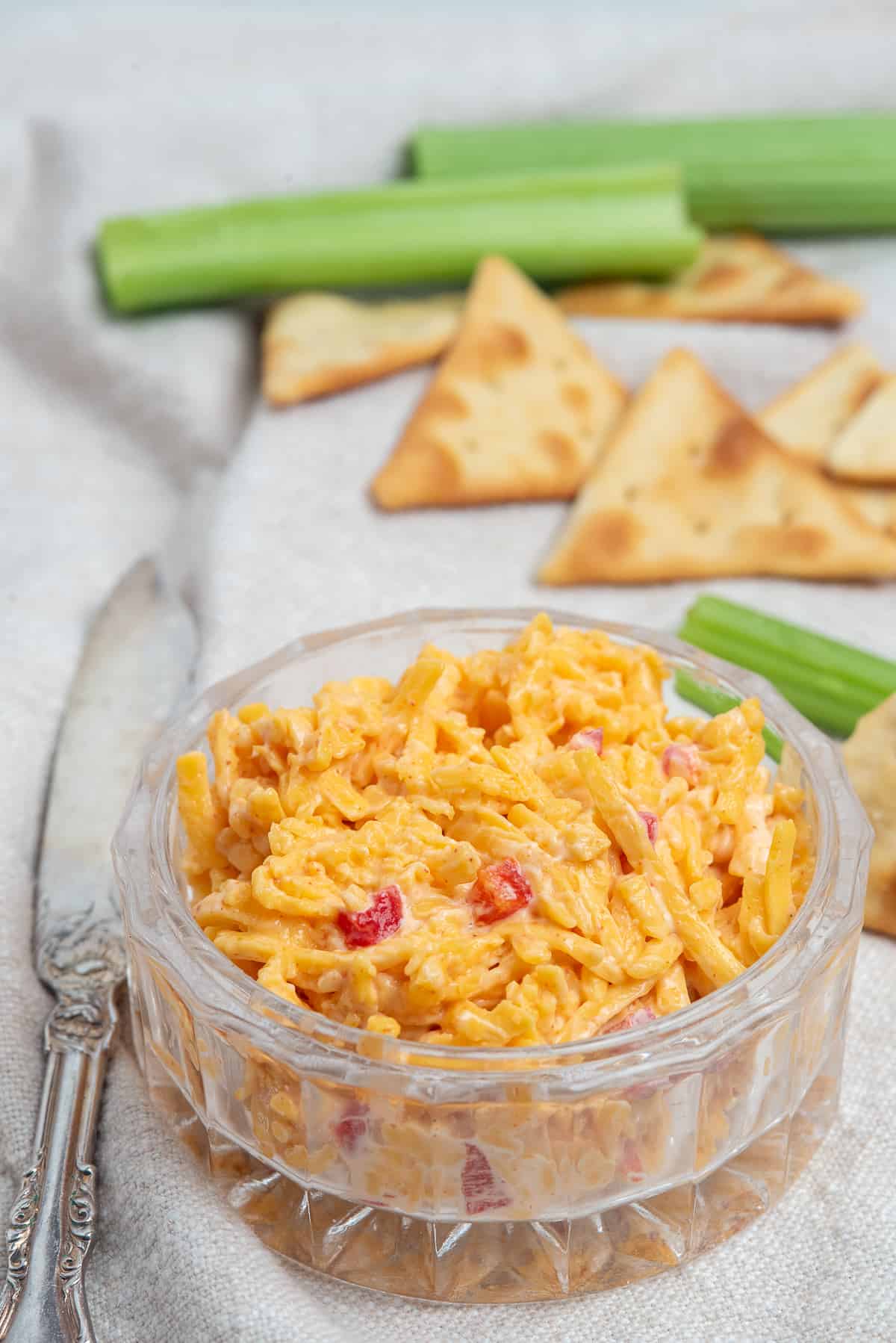 bowl of pimento cheese with celery and crackers. 