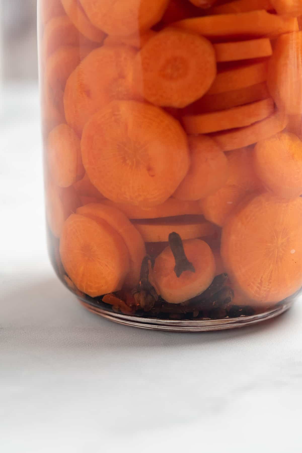 close up of jar of pickled carrots. 