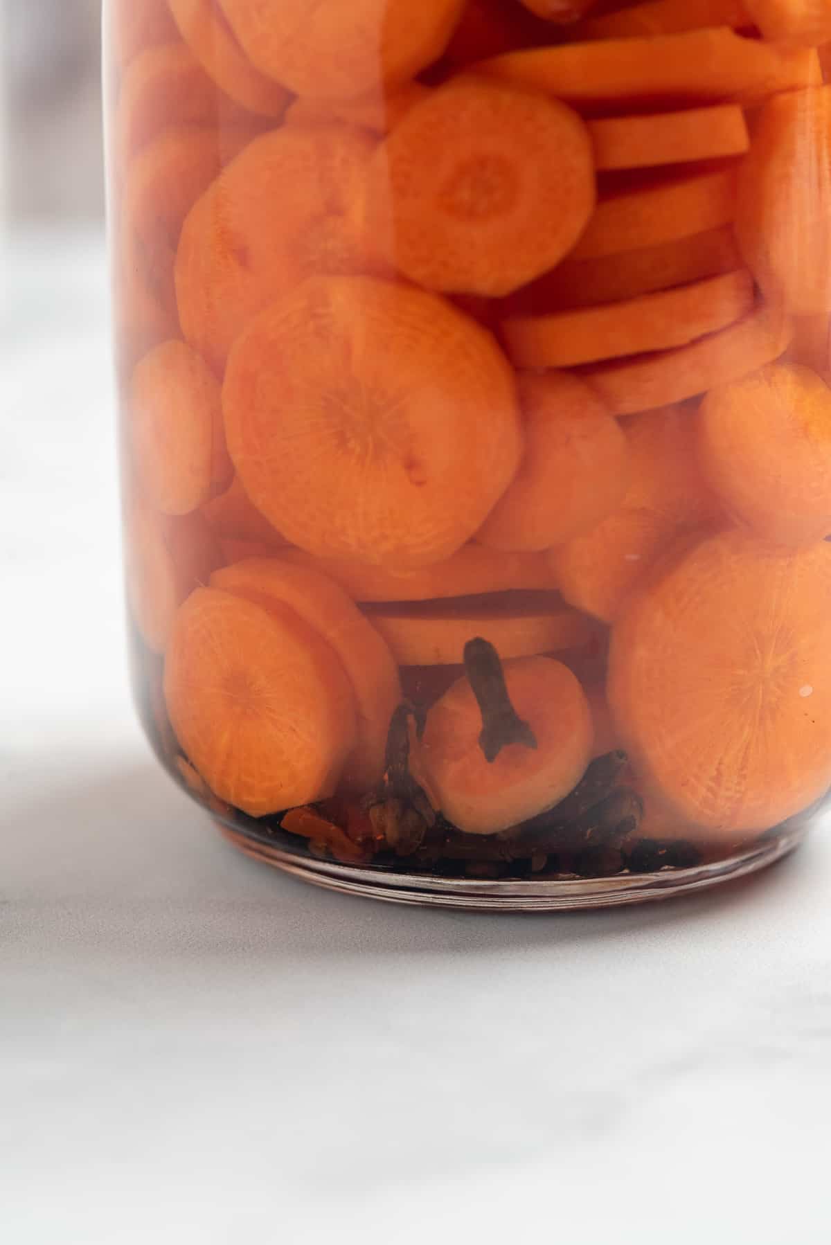 close up of jar of pickled carrots.