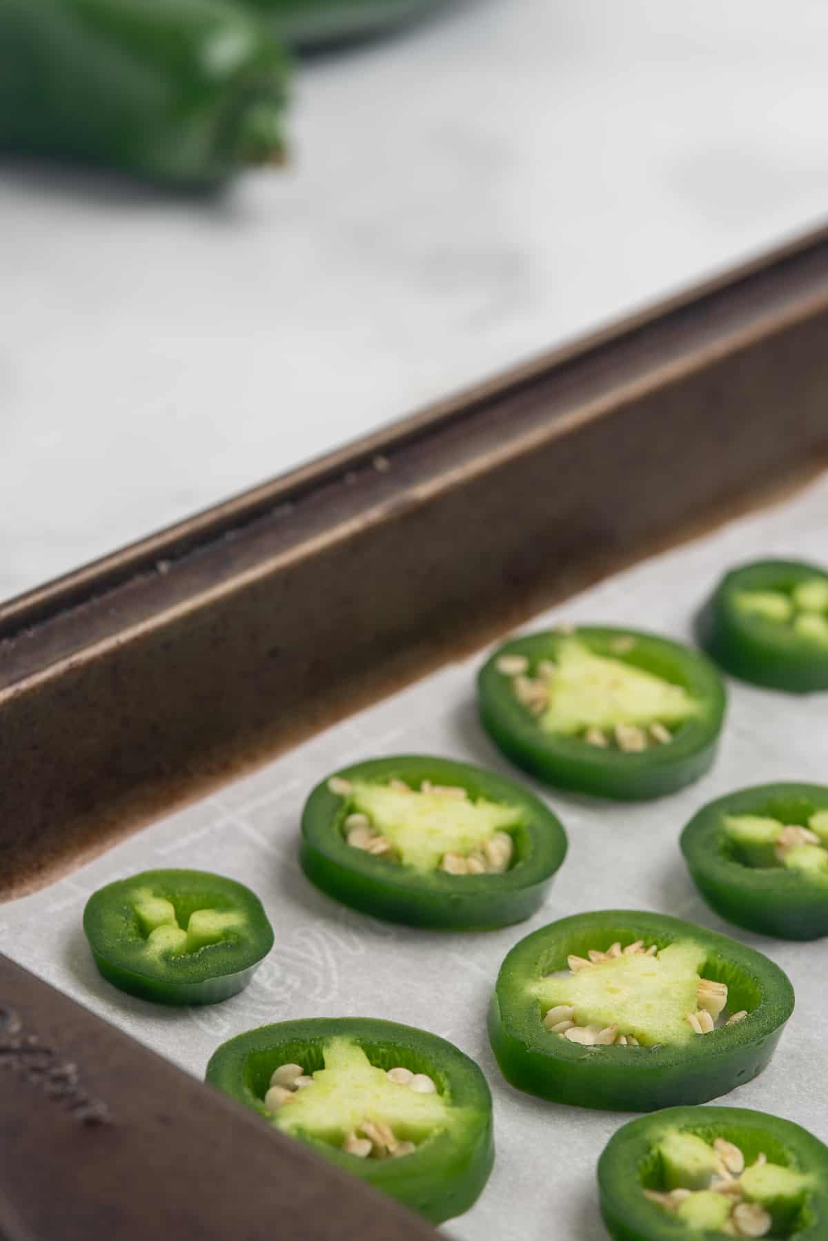 jalapeno slices on parchment paper. 