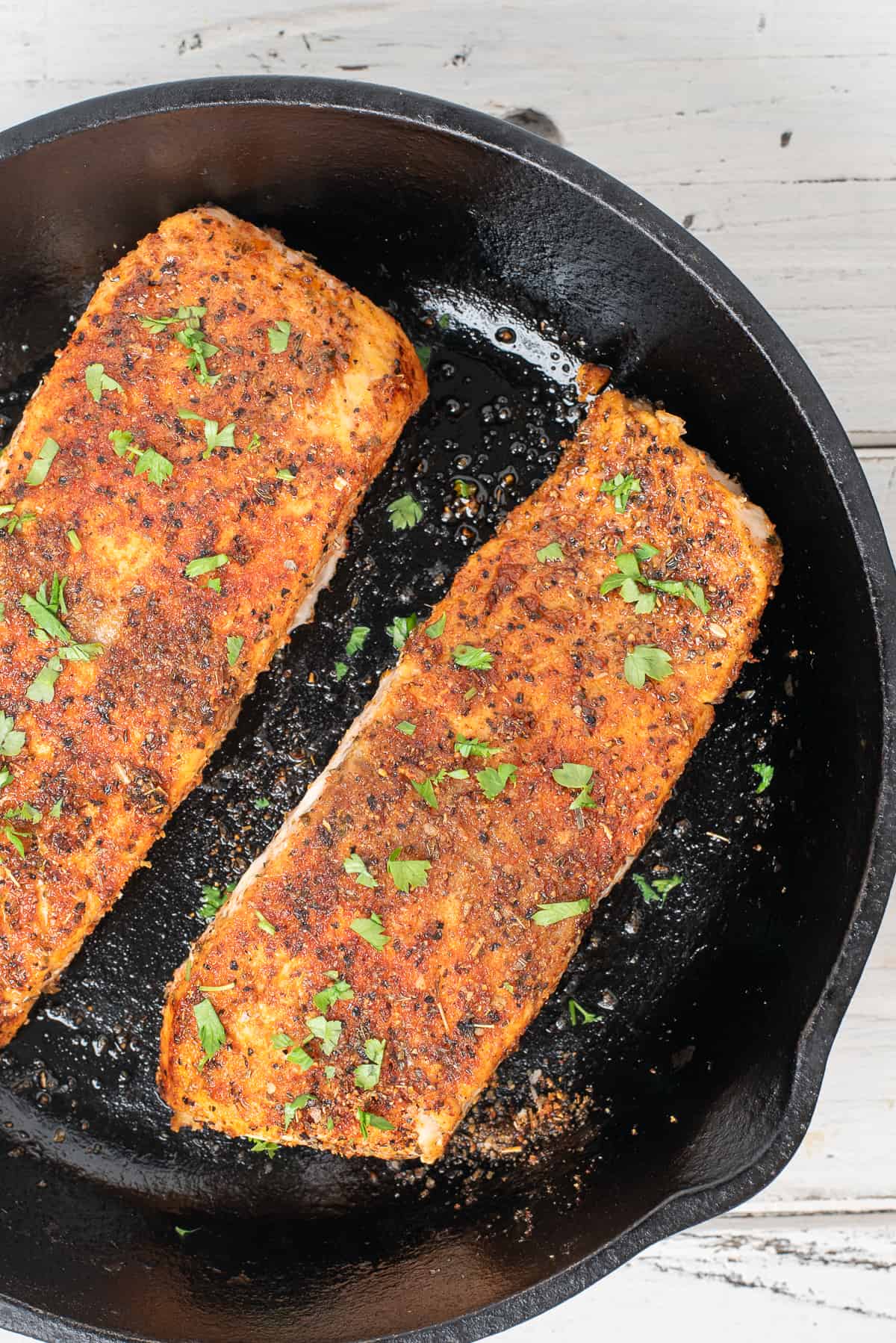 close up of salmon that's been blacked in iron skillet.