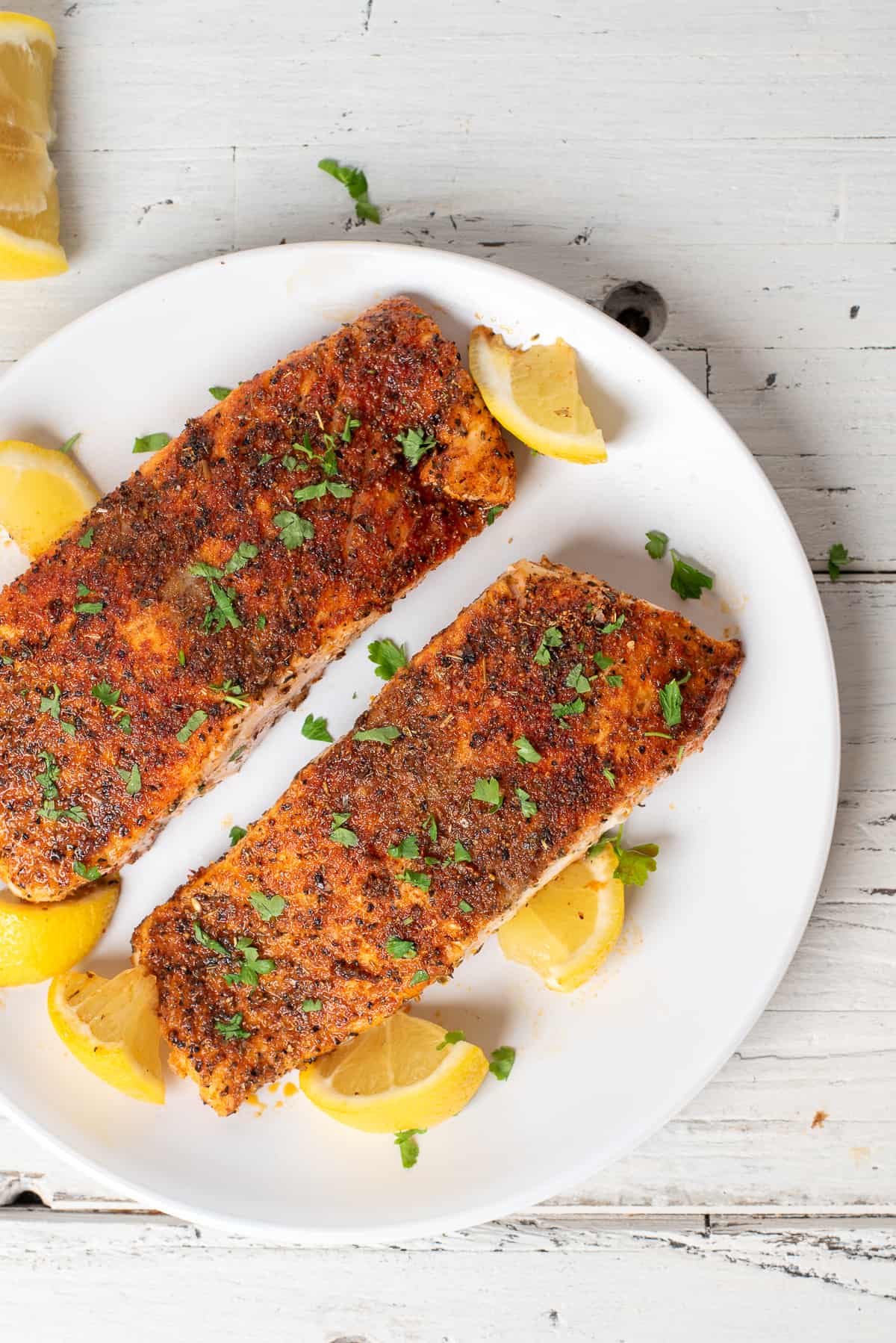 baked blackened salmon on plate. 