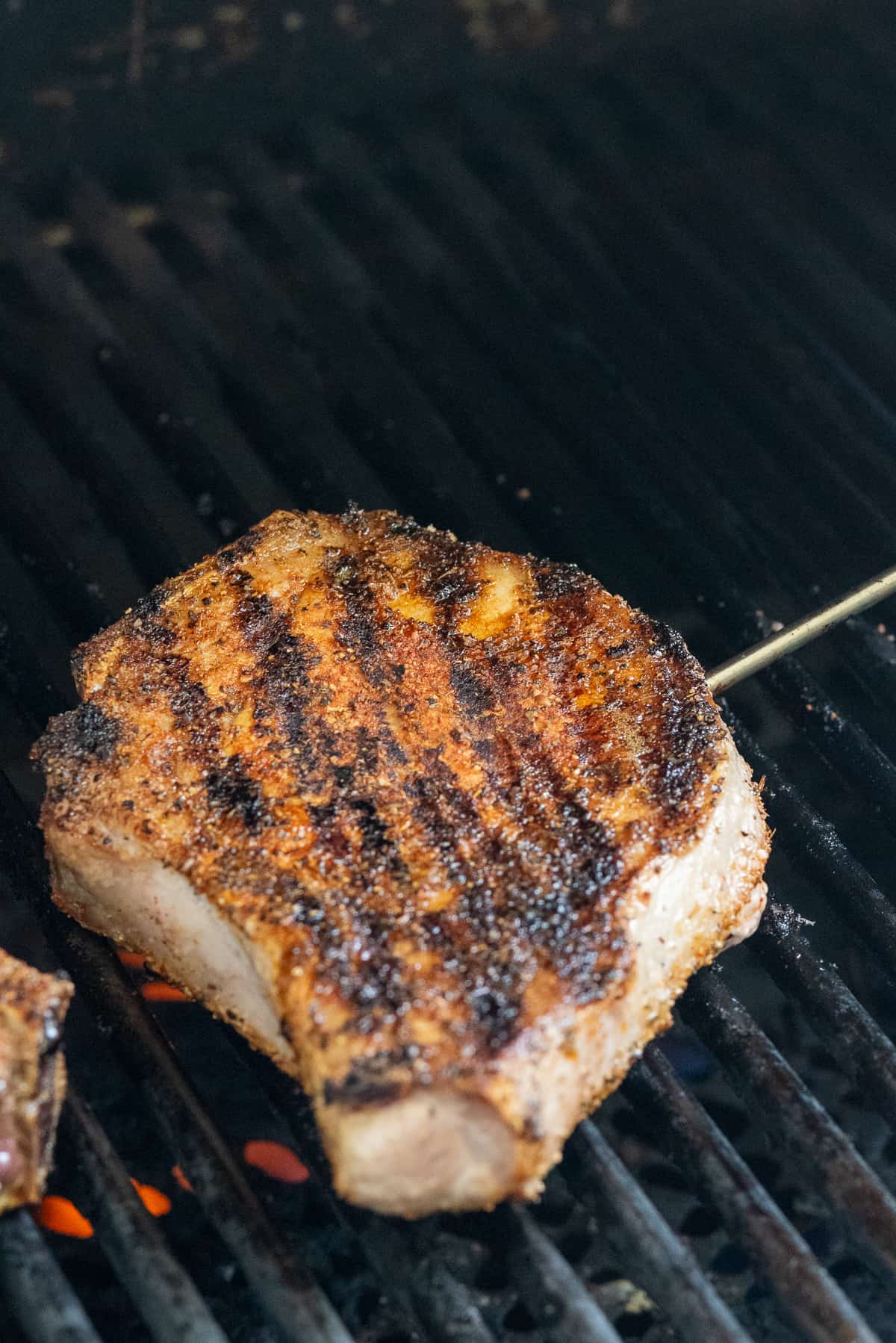 pork chop on grill with temperature probe.