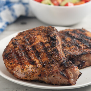 blackened pork chops on plate.