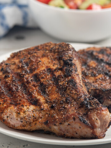 blackened pork chops on plate.