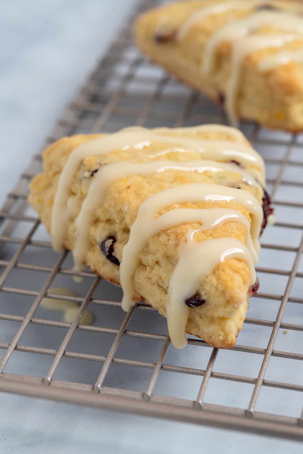 scone with cranberries and orange on a rack.