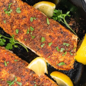 salmon in skillet with lemon.
