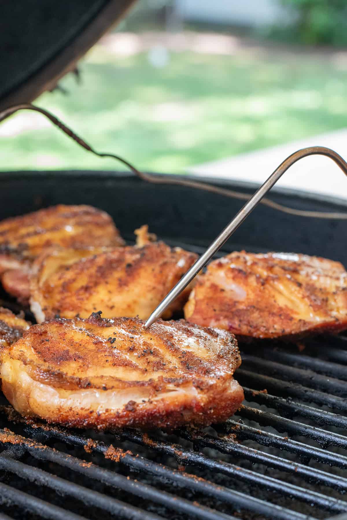 chicken thighs on grill with temperature probe