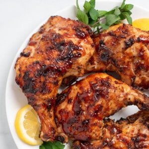 close up of grilled chicken quarters.