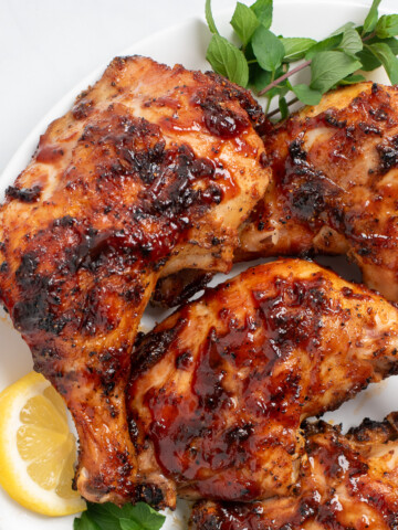 close up of grilled chicken quarters.