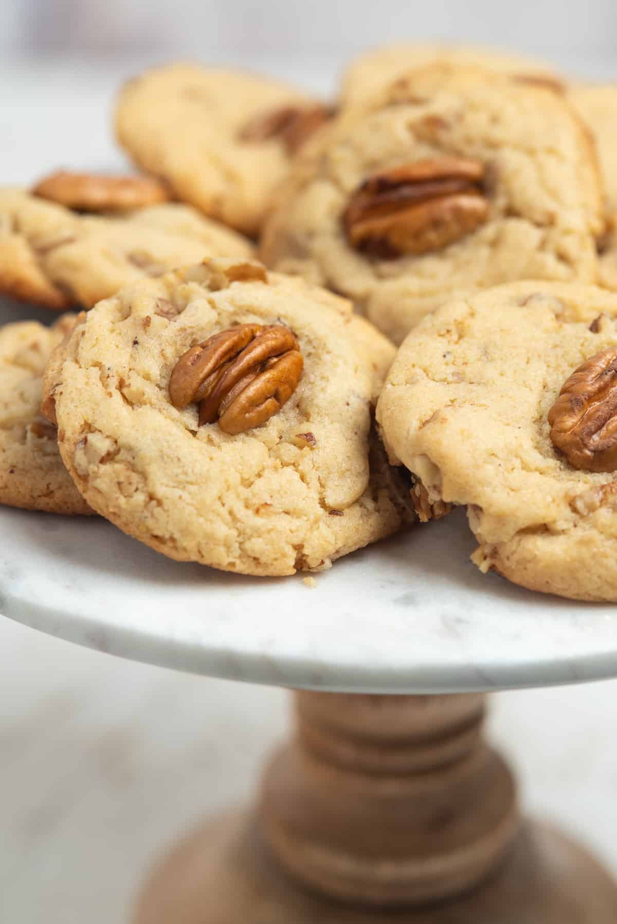 browned butter pecan cookies on pedestal. 