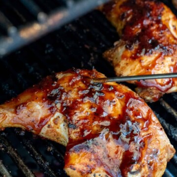 quarter chickens on grill with thermometer probe.